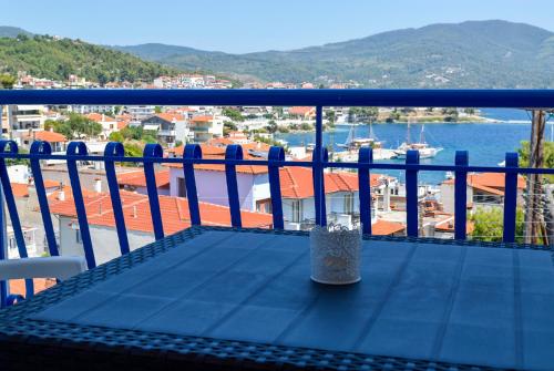a balcony with a table and a view of the water at Pella Hotel - new in Neos Marmaras