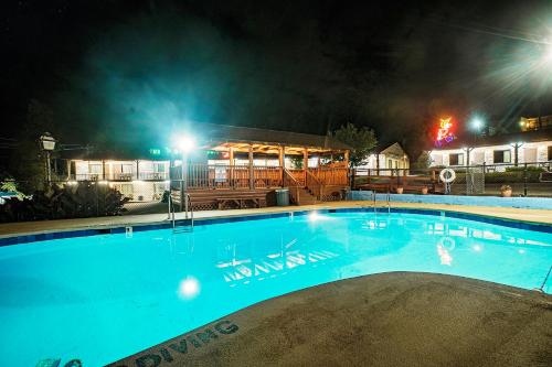 a large swimming pool in front of a house at night at The Mountaineer Inn - Asheville in Asheville