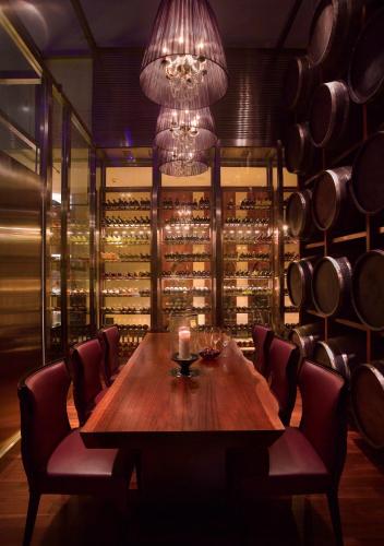 a dining room with a table and a bunch of wine bottles at Grand Hyatt Shenzhen in Shenzhen