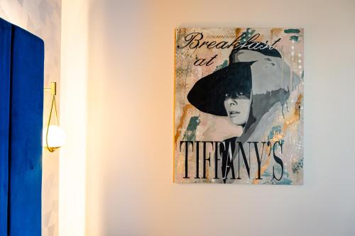 a painting hanging on a wall in a room at The Muse Christchurch Art Hotel in Christchurch