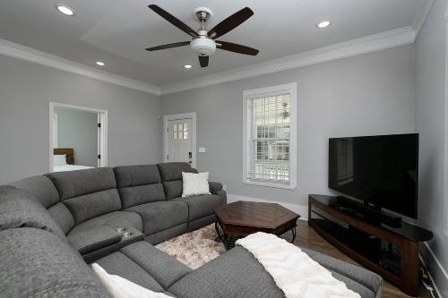 a living room with a couch and a flat screen tv at Atlanta Luxury Vacation Home by Downtown & Airport in Atlanta