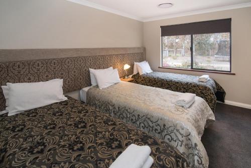 a hotel room with two beds and a window at Redgate Forest Retreat in Witchcliffe