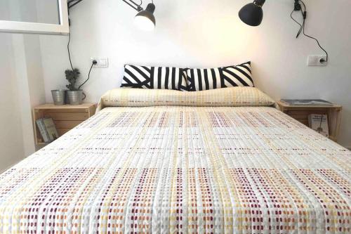 a bedroom with a large bed with a colorful bedspread at Casa La Placeta in Fortaleny
