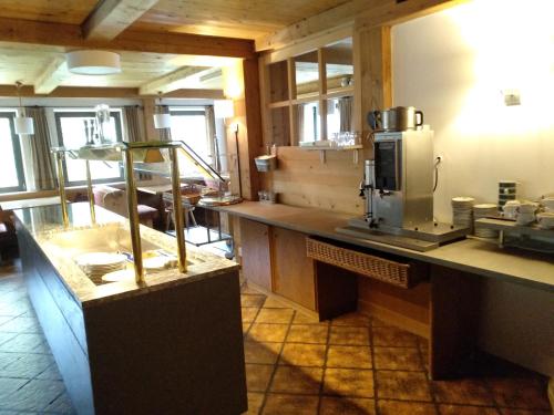 a kitchen with a counter with a coffee maker at Hotel Rainhof in Senales