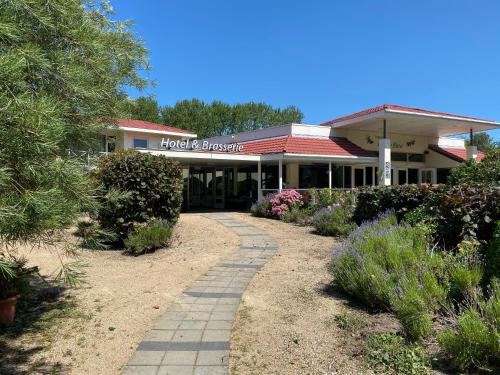 a building with a walkway in front of it at Fletcher Strandhotel Renesse in Renesse