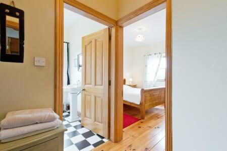 a room with a door leading to a bedroom at Ash House Bed and Breakfast in Calverstown