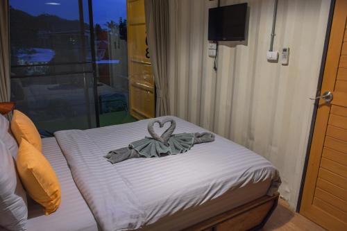 a bed with a towel on top of it at INBOX Living Rimkhong in Chiang Khan