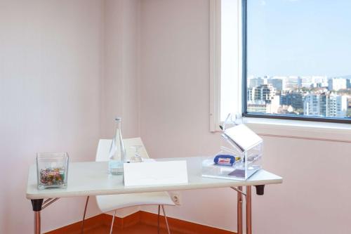 a white desk in a room with a window at Radisson Blu Hotel Lisbon in Lisbon