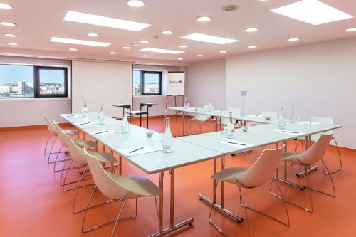 a conference room with a long table and chairs at Radisson Blu Hotel Lisbon in Lisbon