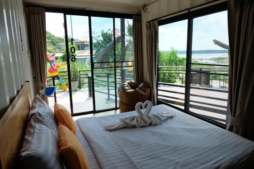 a bedroom with a bed with a bow on it at INBOX Living Rimkhong in Chiang Khan