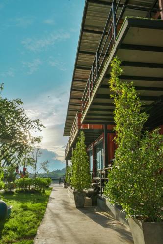 a building with a sidewalk in front of it at INBOX Living Rimkhong in Chiang Khan