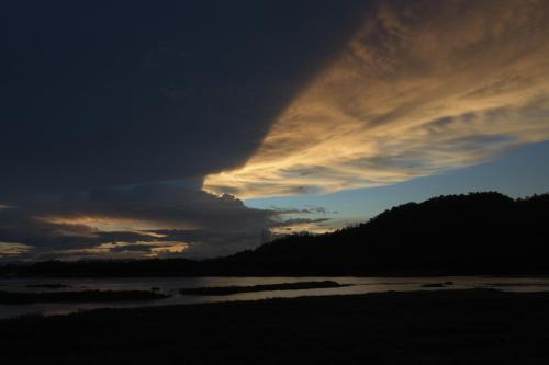 a storm cloud over a beach at sunset at INBOX Living Rimkhong in Chiang Khan
