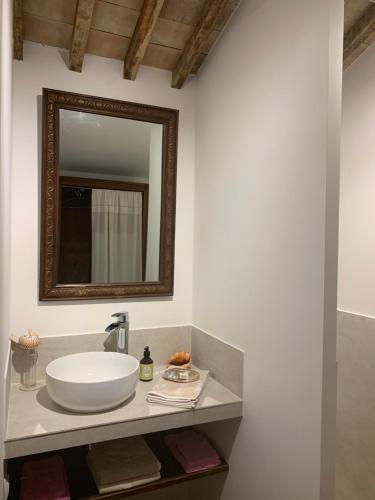 a bathroom with a sink and a mirror on a counter at La Melizanne in Fuveau