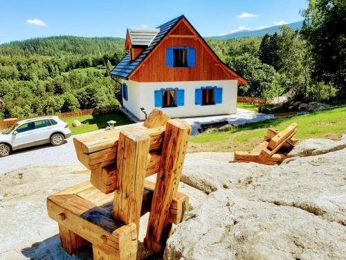 a wooden structure in front of a house at Kolorowe Karkonosze in Przesieka
