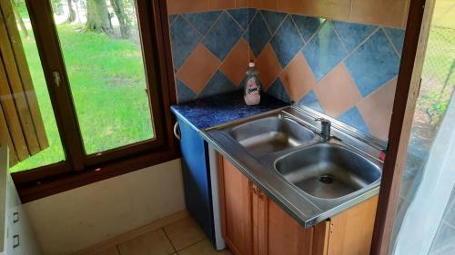 a kitchen with a sink next to a window at Integracyjne Centrum Opieki Wychowania Terapii in Serock