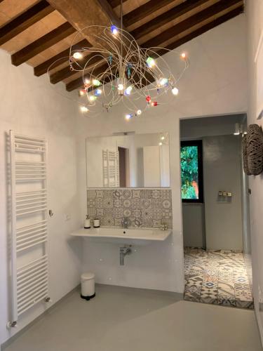 a bathroom with a sink and a chandelier at Borgo Crispiero in Crispiero