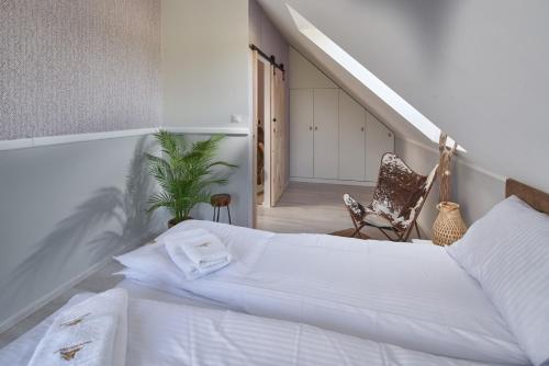 a bedroom with a large bed and a staircase at Nadmorski Zaułek in Jastrzębia Góra