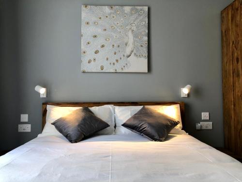 a bedroom with a white bed with two pillows at Apartments by Sliema promenade and beach in Sliema