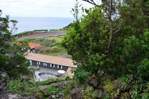 a house on a hill next to the ocean at Casa dos Botes - WhaleBoat House TER in São Caetano
