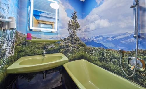 a bathroom with a sink and a bath tub at Ski & Bike Appartements Forsthaus in Saalbach Hinterglemm
