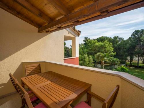 a wooden table and chairs on a balcony at Apartments Villa Rossella 1 in Rovinj