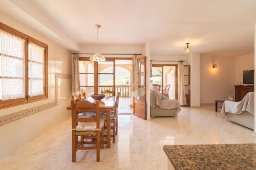 a living room with a table and chairs at Can Cega in Bunyola
