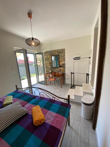 a bedroom with a bed with a colorful blanket at Apartments Apartim Piran in Piran