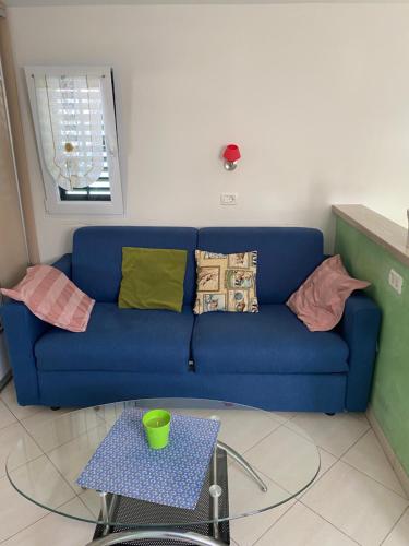a blue couch in a living room with a table at Apartments Apartim Piran in Piran
