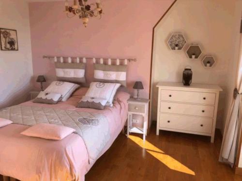 a bedroom with two beds and a dresser at Le CLOS DE L AMANDIER in Château-Chalon