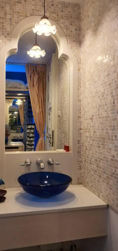 a bathroom with a blue sink and a mirror at marrakesh มาราเกซ หัวหิน in Hua Hin