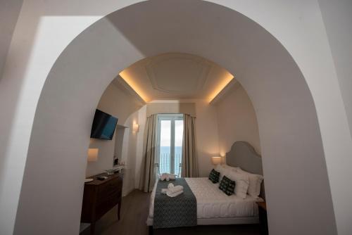 a hotel room with a bed and a window at Domus Centro Tropea in Tropea