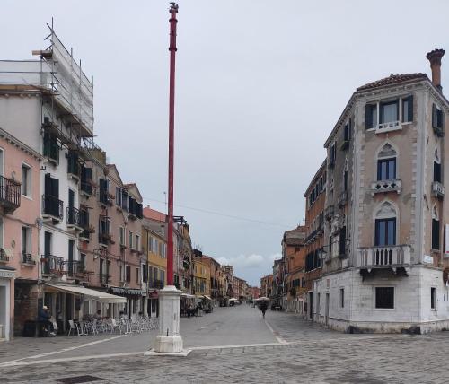 an empty city street with buildings and a pole at BIENNALE APARTMENT NEAR SAN MARCO in Venice