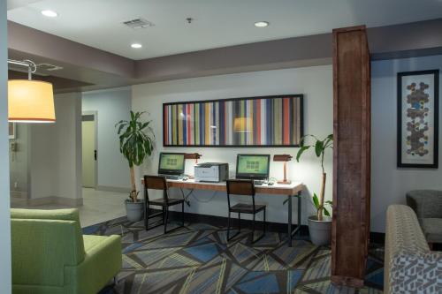 a lobby with a desk with two computers and chairs at Holiday Inn Express Hotel and Suites Natchitoches, an IHG Hotel in Shamard Heights