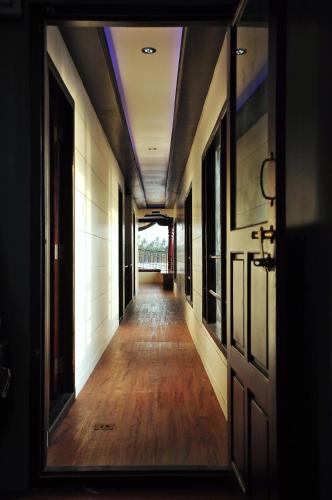 an empty hallway in a building with a mirror at Vaishnav Tours in Alleppey