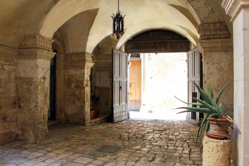 an entrance to an old building with an open door at B&B Palazzo Sambiasi in Lecce