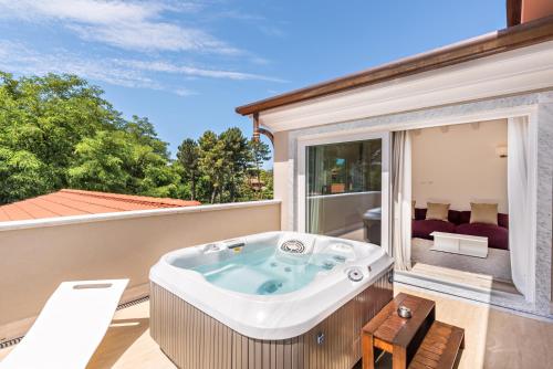 a hot tub on the balcony of a house at Hotel Stella Della Versilia in Marina di Massa