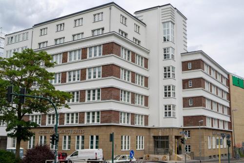a tall white building on the corner of a street at Trip Inn Hotel & Suites Essen in Essen