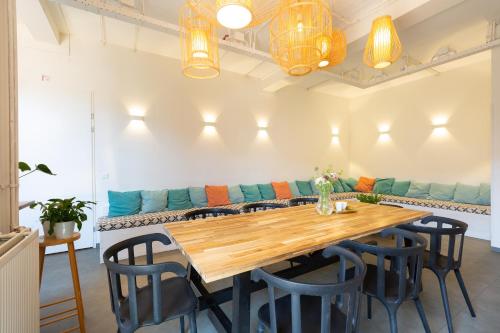 a dining room with a table and a couch at Pink Flamingo Boutique Hostel in The Hague