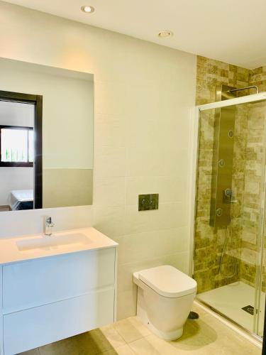 a bathroom with a toilet and a sink and a shower at Playa and Chill in San Juan de los Terreros
