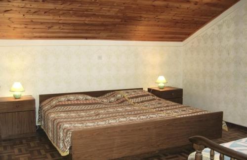 a bedroom with a large bed with two night stands at House Kampor (895) in Kampor