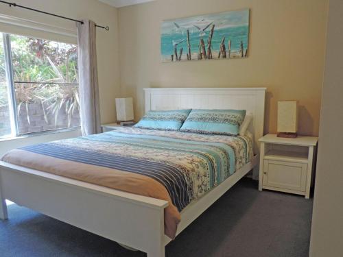 a bedroom with a bed and a large window at Adriana 3 unit with a backyard in Shoal Bay