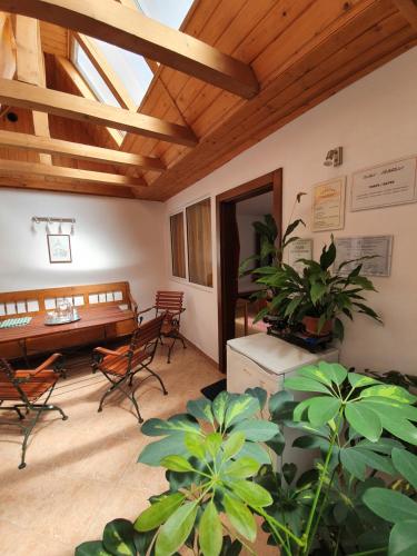 a room with a table and chairs and a wooden ceiling at Casa Terezia in Braşov