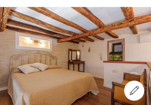 a bedroom with a bed in a room with wooden ceilings at Fabrizia Apartment in Castellammare del Golfo