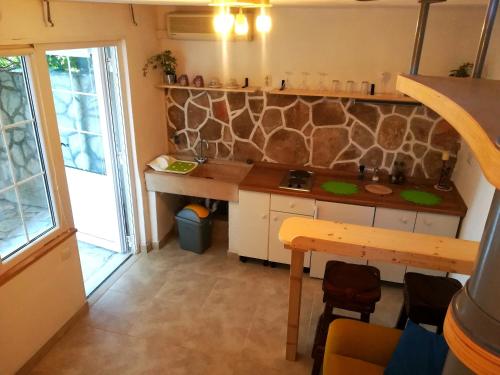 a kitchen with a counter and a stone wall at Veroko in Hvar