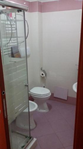 a bathroom with a toilet and a sink at Lattanzio's Residence in Margherita di Savoia