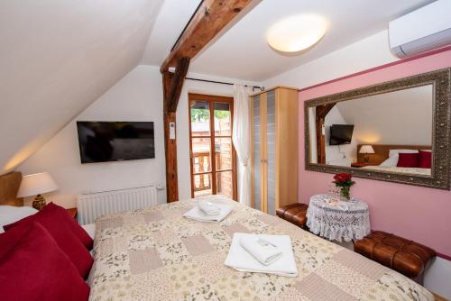 a bedroom with a bed and a mirror at Ubytování u BÍLÉ PANÍ in Český Krumlov