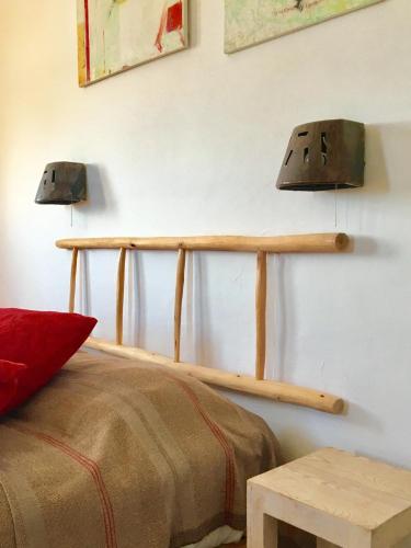 a bedroom with a bed and two lights on the wall at Auberge De La Plage in Sidi Kaouki