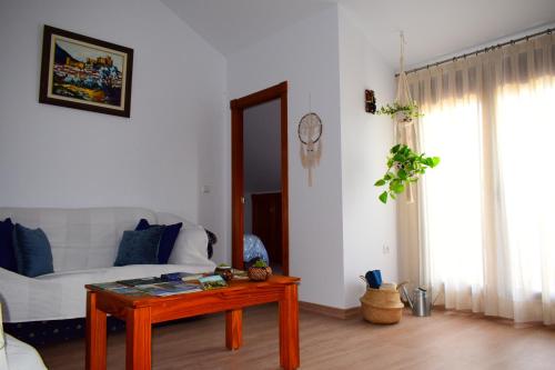 a living room with a couch and a table at El Ático de La Casa Viva in Vélez Blanco
