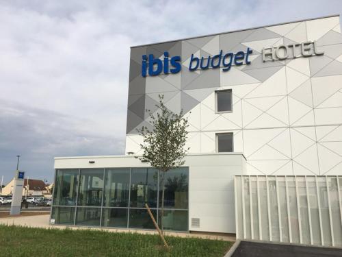 a building with a sign on the front of it at ibis budget Beauvais Aeroport in Beauvais