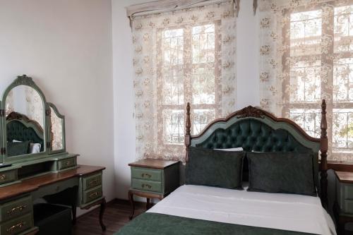 a bedroom with a bed and a dresser and a mirror at White Garden Hotel-Adult Only in Antalya